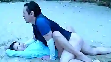 Korean brunette is sucking dick and getting a rear fuck on the beach, in the late afternoon