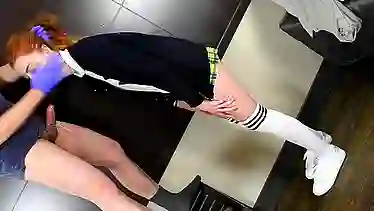 Red haired schoolgirl with pigtails, Megan Winter is kneeling on the floor and sucking a huge dick