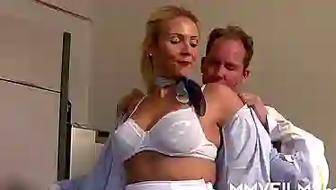 German Stewardess gives facial to a male employee in a company setting